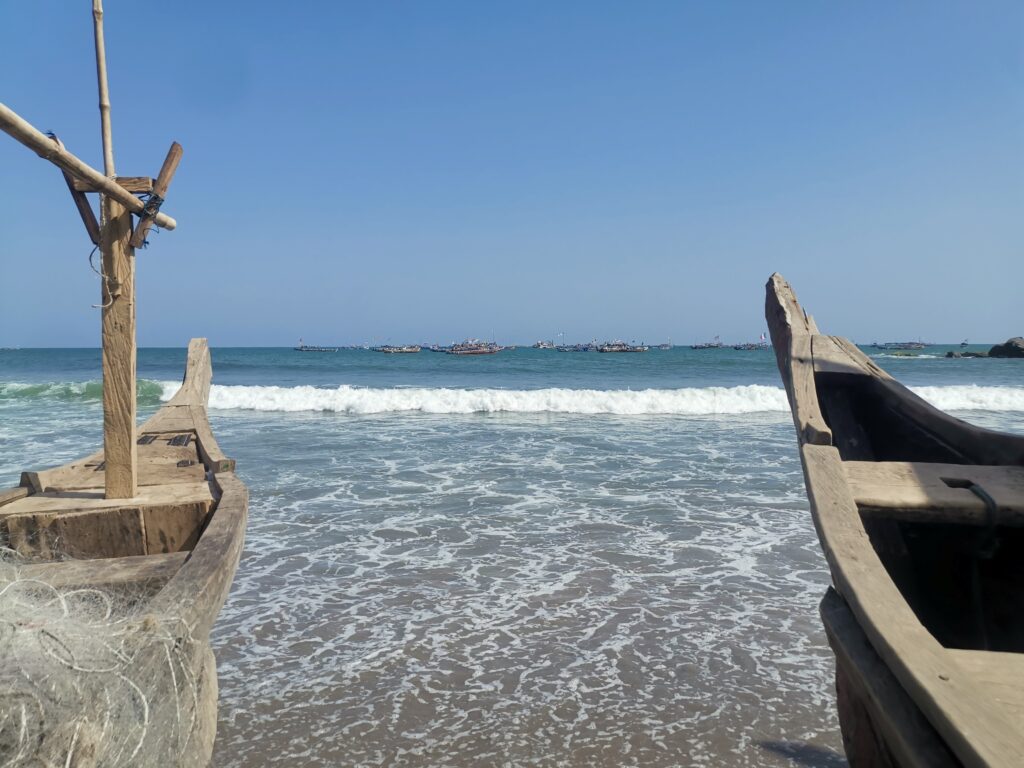 A view from the beach looking out at boats on the water.